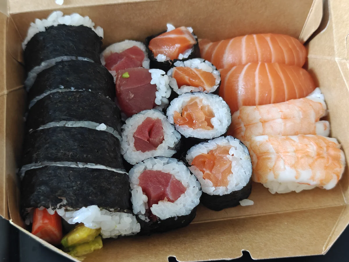 A cardboard box of Japanese food in Ho Chi Minh City — a perfectly reasonable life choice at any hour.